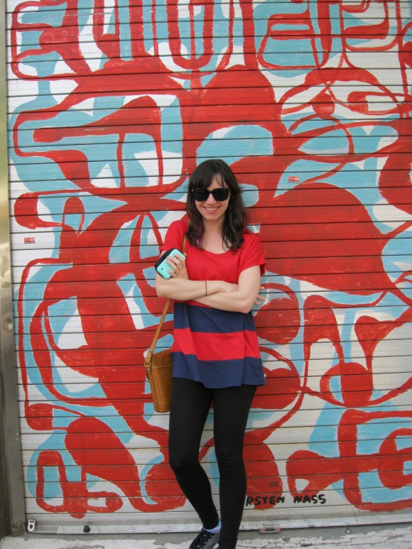 posing against a colorful wall